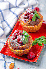 Image showing Mini tarts with raspberry, frangipani and mint.