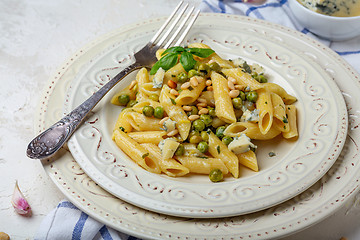 Image showing Italian pasta with green peas and blue cheese.