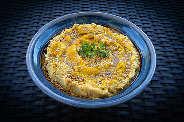 Image showing Tasty hummus (or houmous) in blue bowl