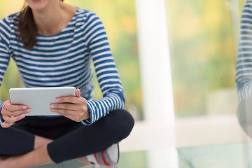 Image showing young women using tablet computer on the floor