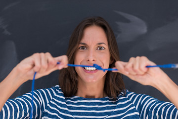 Image showing woman holding a internet cable in front of chalk drawing board