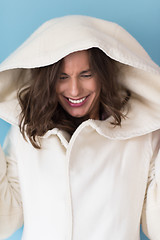 Image showing woman in a white coat with hood isolated on blue background