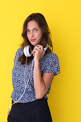 Image showing woman with headphones isolated on a yellow