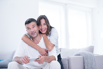 Image showing happy couple using mobile phone at home