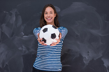 Image showing woman holding a soccer ball in front of chalk drawing board