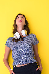 Image showing woman with headphones isolated on a yellow