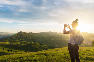 Image showing Woman taking photo in mountain