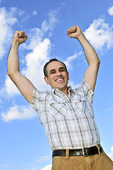 Image showing Happy man raising hands in victory