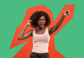 Image showing Winning success woman happy ecstatic celebrating being a winner. Dynamic energetic image of female afro model