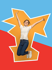 Image showing Freedom in moving. Pretty young woman jumping against orange background