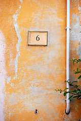 Image showing orange painted wall with the number six