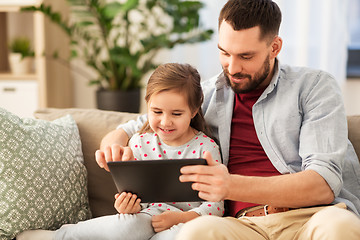 Image showing father and daughter with tablet computer at home