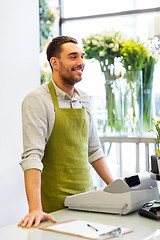 Image showing florist man or seller at flower shop counter