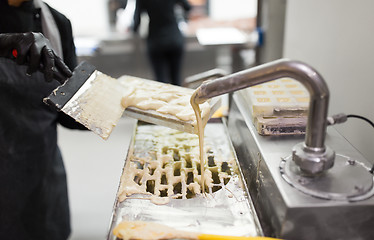 Image showing confectioner makes chocolate candies at sweet-shop