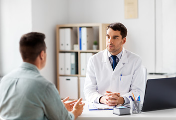 Image showing doctor with laptop and male patient at hospital