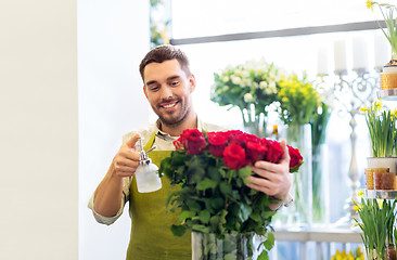 Image showing florist or seller setting red roses at flower shop