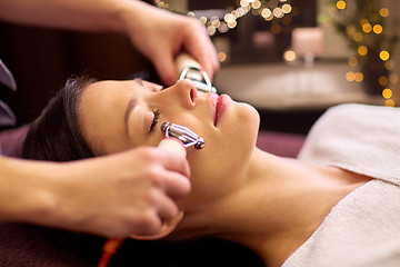 Image showing woman having hydradermie facial treatment in spa