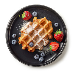 Image showing freshly baked belgian waffle on black plate