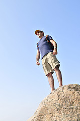 Image showing Hiker standing on a rock