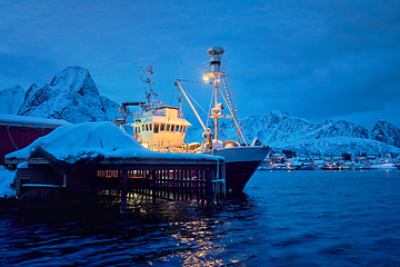 Image showing Fishing boat in Reine village at night. Lofoten islands, Norway