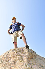 Image showing Hiker standing on a rock