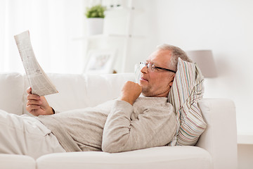 Image showing senior man reading newspaper at home