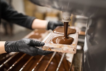 Image showing confectioner makes chocolate candies at sweet-shop