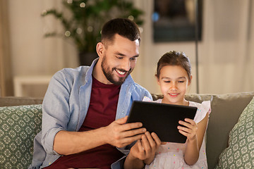 Image showing father and daughter with tablet computer at home