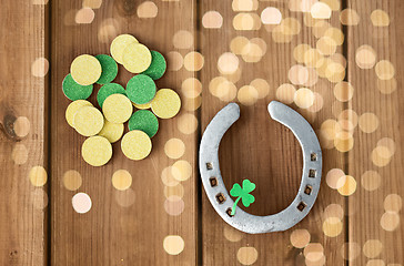 Image showing horseshoe with shamrock on wooden background