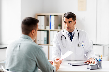 Image showing doctor giving prescription to patient at hospital