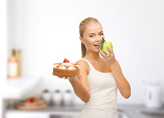 Image showing happy woman eating apple instead of cake