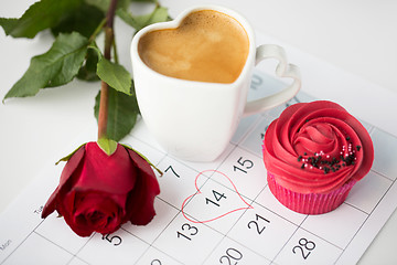 Image showing close up of calendar, coffee, cupcake and red rose