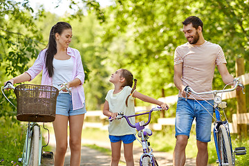 Image showing happy family with bicycles in summer park