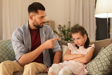 Image showing upset or feeling guilty girl and father at home