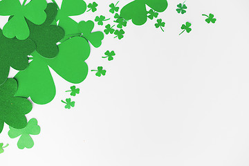 Image showing green paper shamrocks on white background