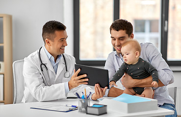 Image showing father with baby and doctor with tablet at clinic