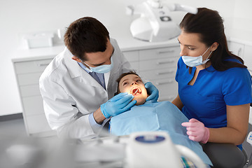 Image showing dentist checking for kid teeth at dental clinic