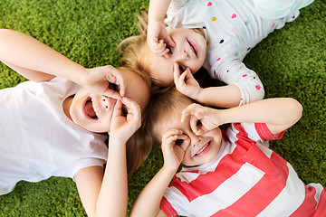 Image showing happy little kids looking through finger glasses