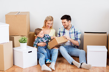 Image showing happy family with boxes moving to new home