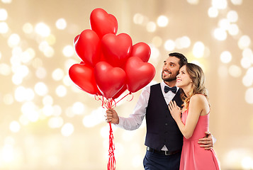 Image showing happy couple with red heart shaped balloons