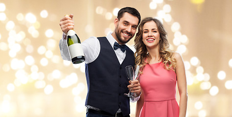 Image showing happy couple with bottle of champagne and glasses