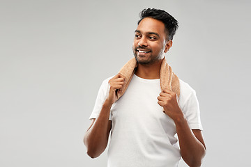 Image showing smiling indian man with towel over grey background