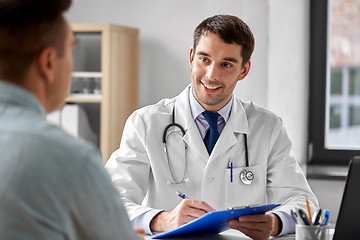 Image showing doctor with clipboard and male patient at hospital