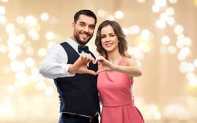 Image showing happy couple making hand heart on valentines day