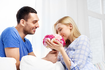 Image showing happy couple with flowers at home