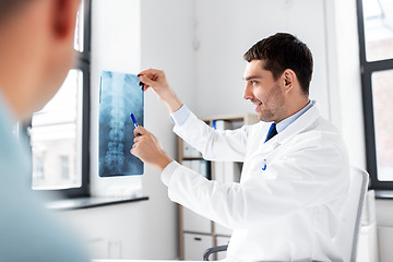 Image showing doctor showing x-ray to patient at hospital