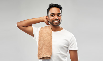 Image showing smiling indian man with towel over grey background