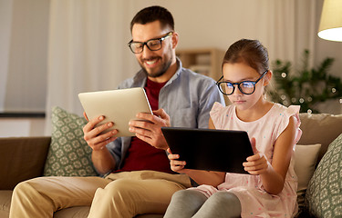 Image showing father and daughter with tablet computers at home