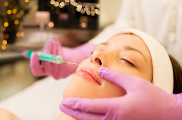 Image showing beautician doing beauty injection to woman lips