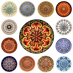 Image showing Set of decorative ceramic dishes hand-painted with acrylic paints floral pattern isolated on white background